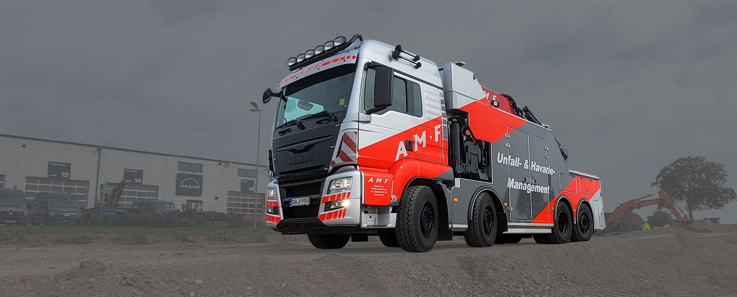 Abschleppwagen für LKW auf Schotterweg vor MAN Halle.
